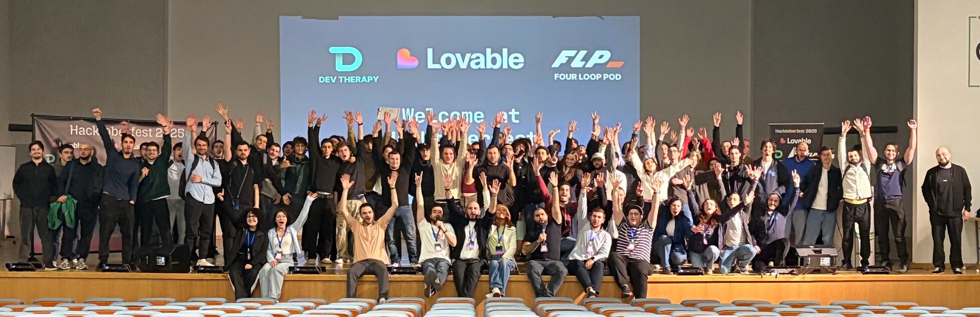 HACKTOBERFEST 2025 group photo on stage at the Free University of Tbilisi