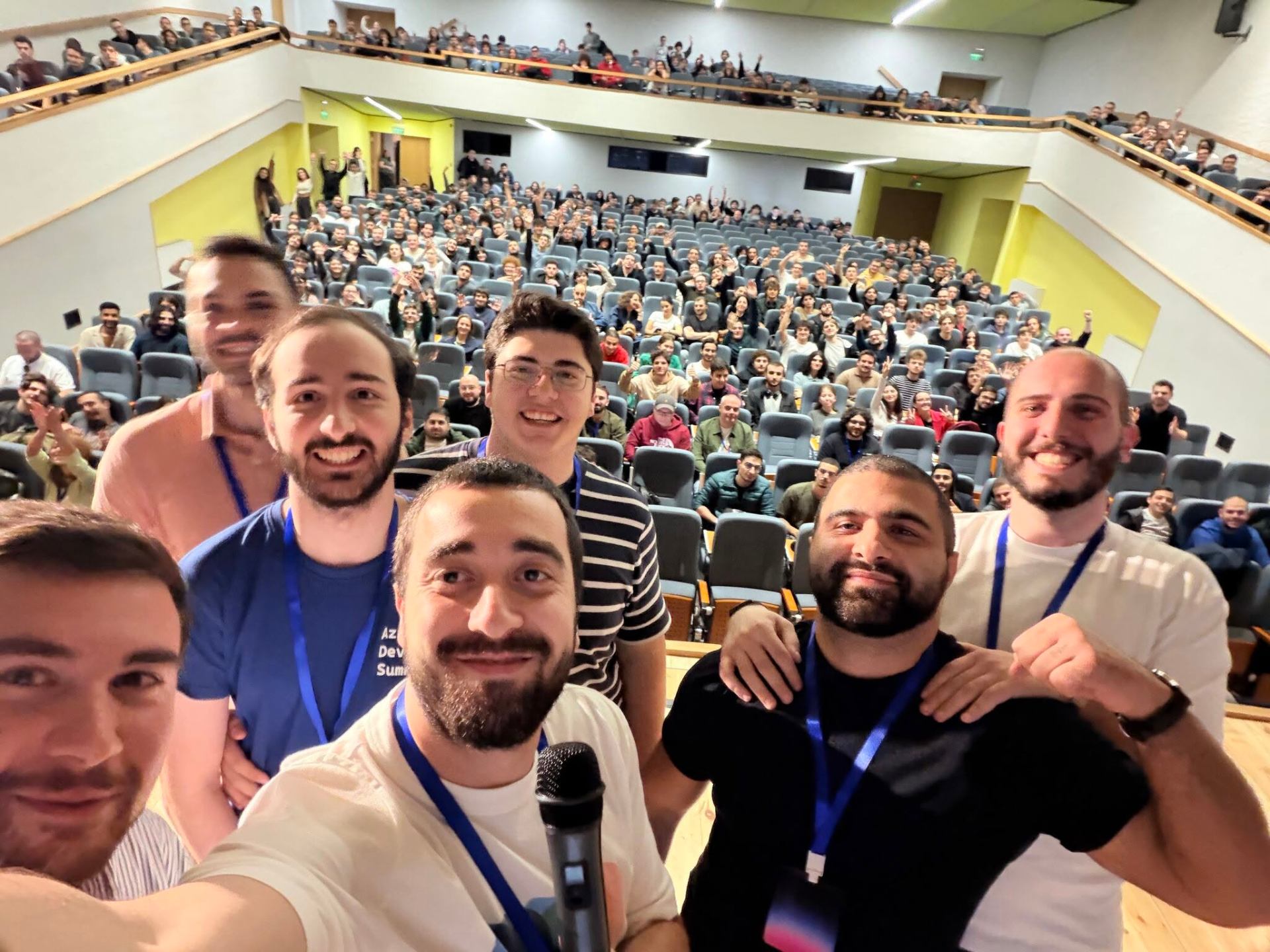 HACKTOBERFEST 2025 organizers selfie with the packed auditorium at the Free University of Tbilisi
